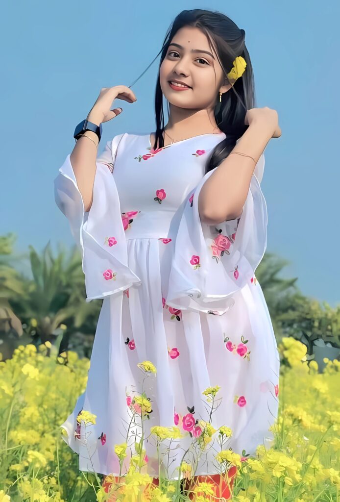 Real girl photo in mustard flower field wearing white floral dress under blue sky