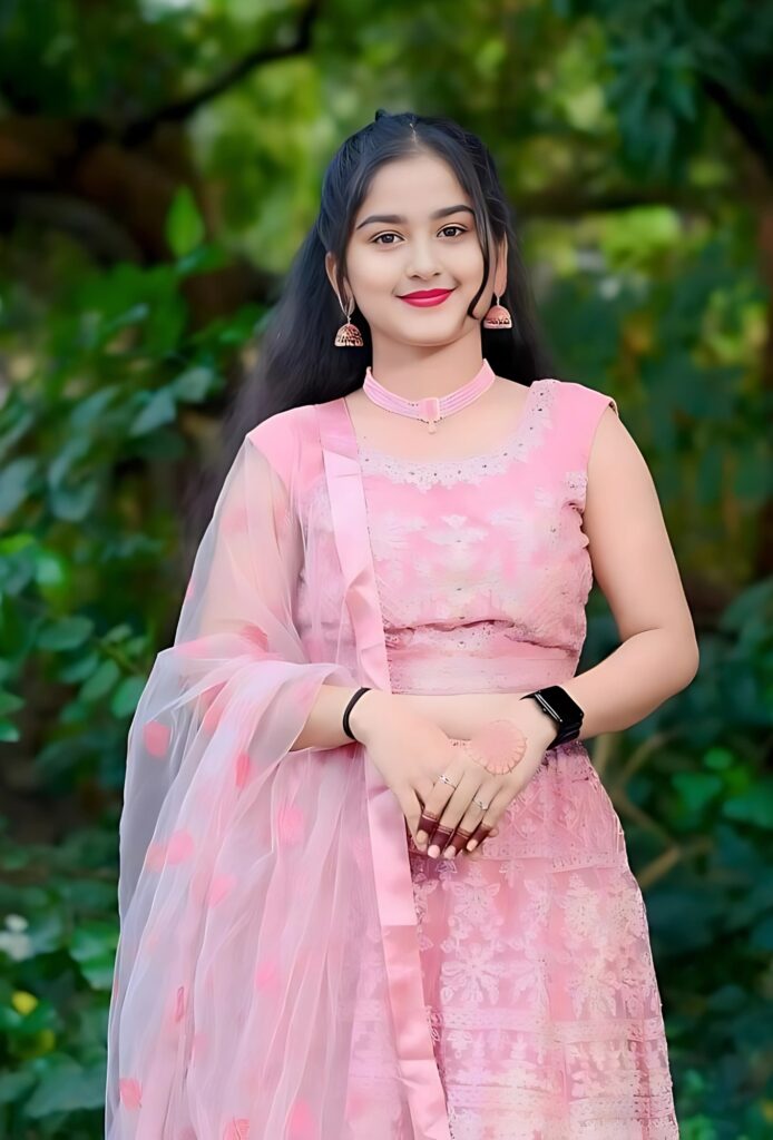 Beautiful Indian girl in traditional pink dress posing outdoors for WhatsApp profile photo
