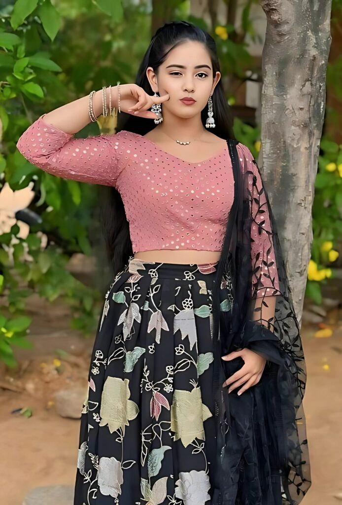 Real girl pic HD in ethnic outfit with pink blouse and black floral lehenga posing outdoors