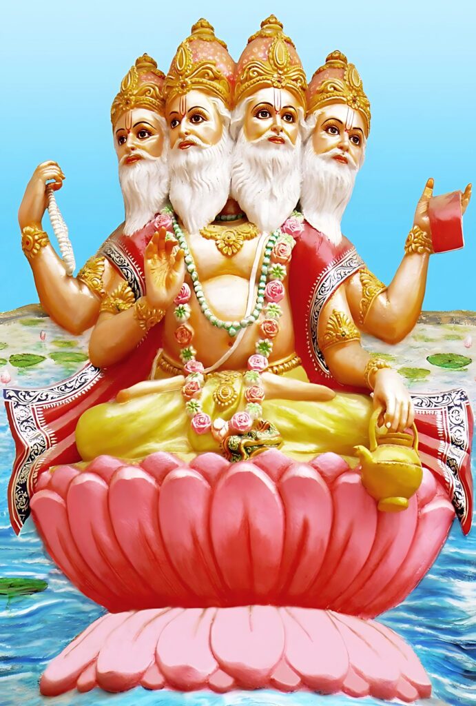 Lord Brahma HD phone wallpaper – Hindu deity of creation with four faces, seated on a pink lotus, holding sacred scriptures, a water pot, and prayer beads, against a serene blue sky background