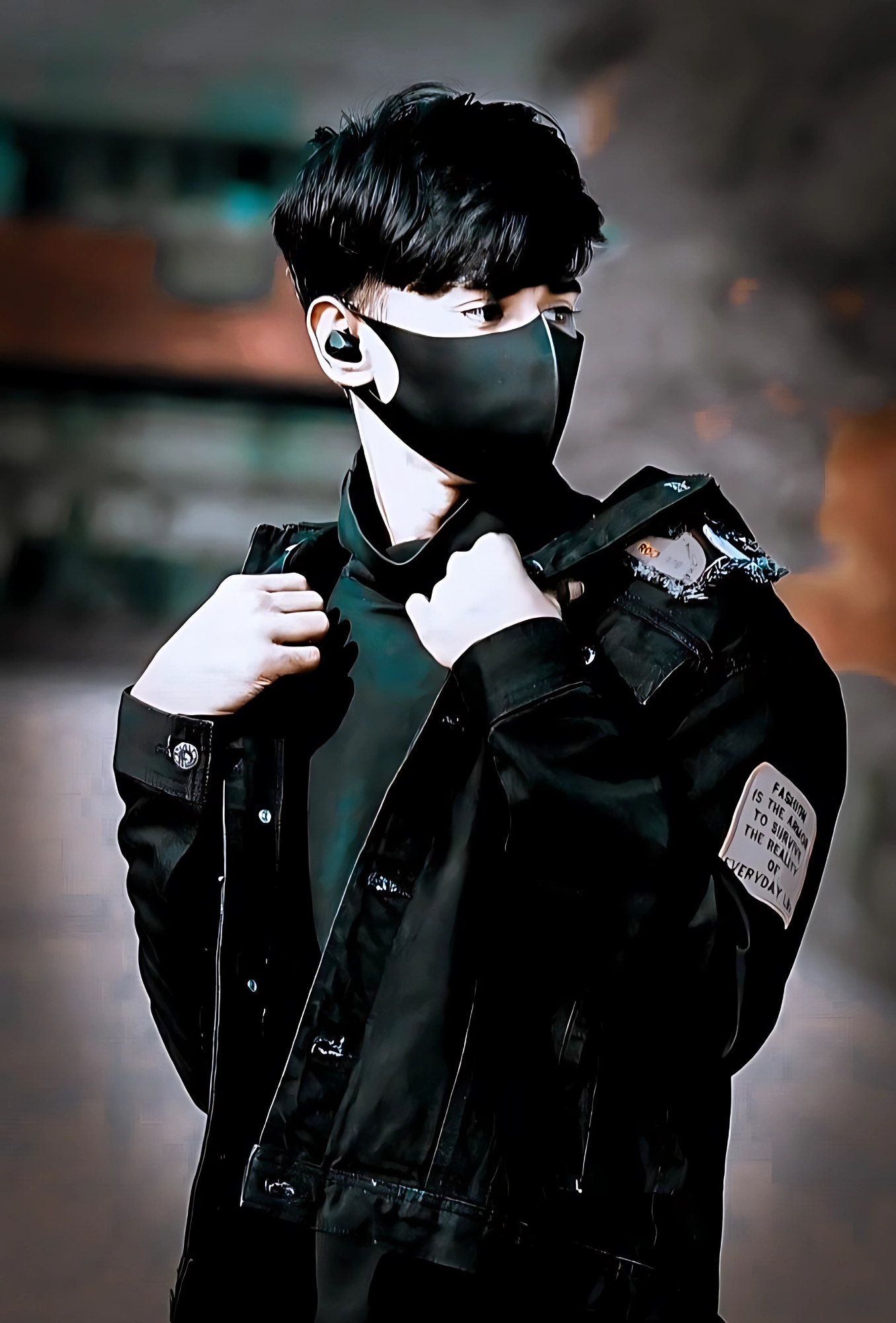 Stylish boy wearing black mask and jacket, showing attitude with a cool pose