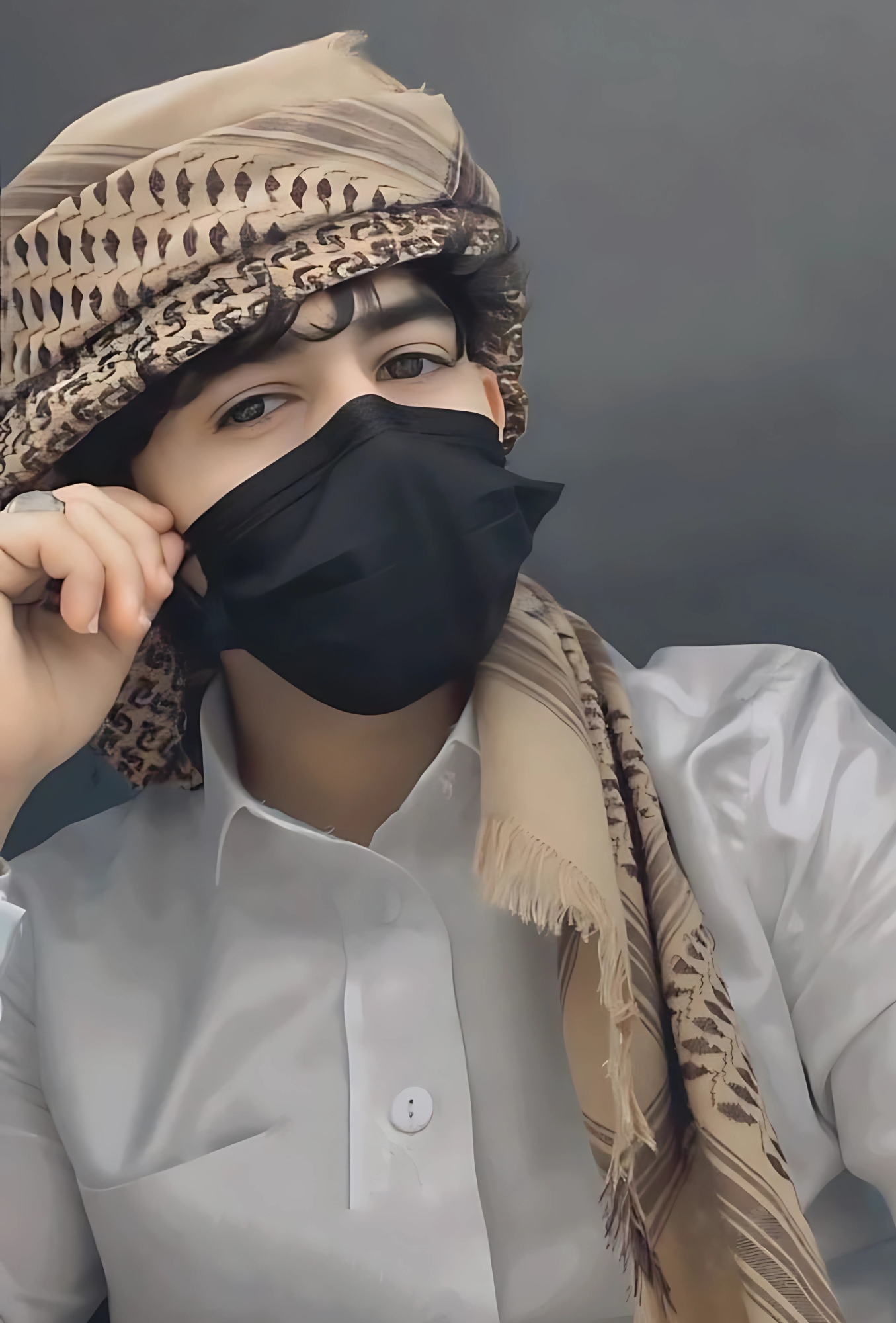 Muslim boy wearing a traditional keffiyeh and black face mask in a white dress shirt, posing for stylish profile picture.
