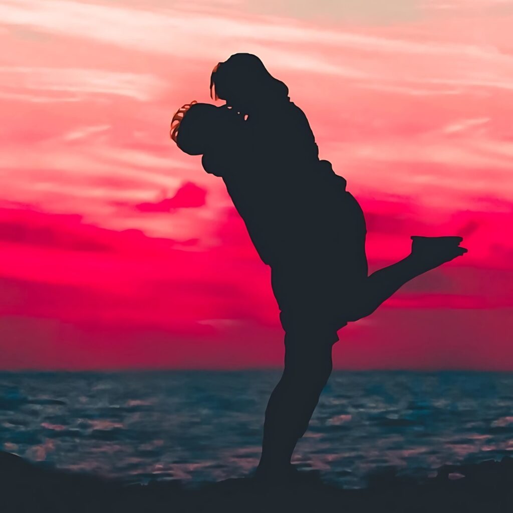 Silhouette of a romantic couple embracing by the sea during a vivid pink and red sunset, symbolizing love and togetherness – perfect for WhatsApp DP or romantic couple profiles