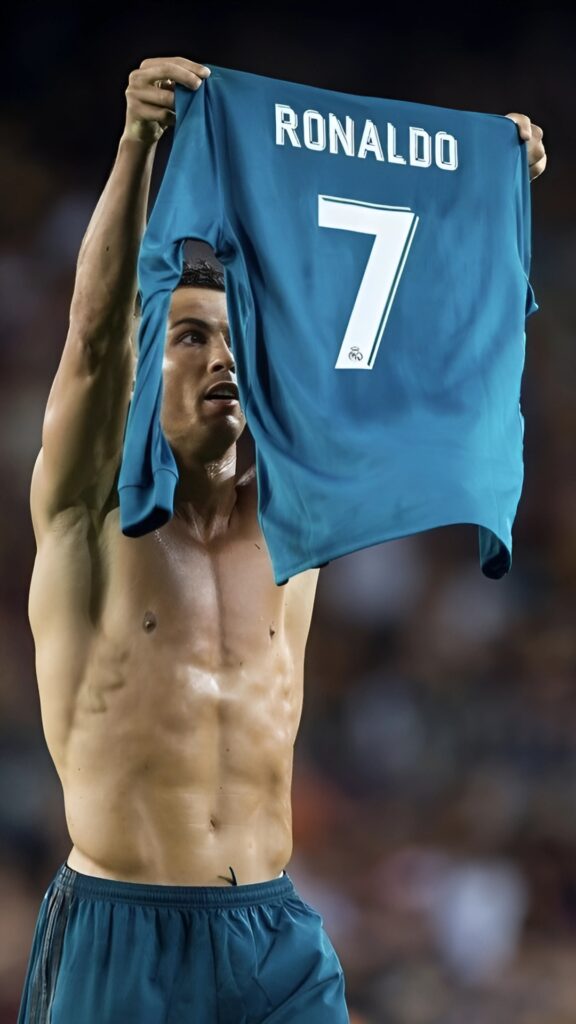 Shirtless Cristiano Ronaldo holds up a blue Real Madrid jersey with "RONALDO" and the number 7.