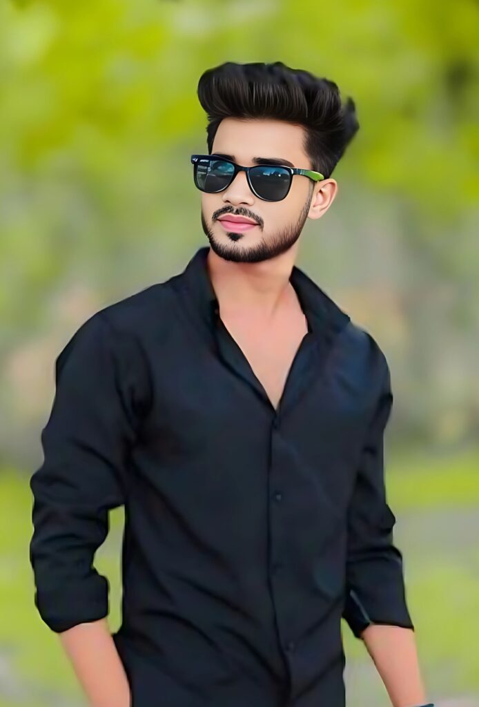 Smart single boy wearing black shirt and sunglasses posing confidently outdoors with green blurred background