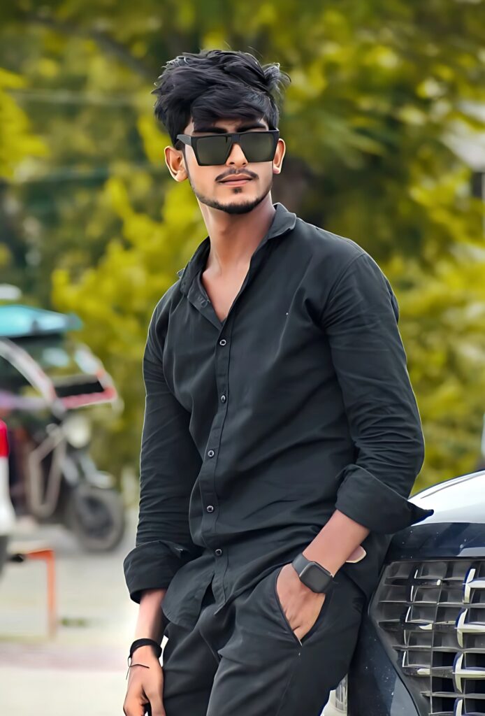 Stylish single boy posing in black outfit beside a car, wearing sunglasses with a confident expression.