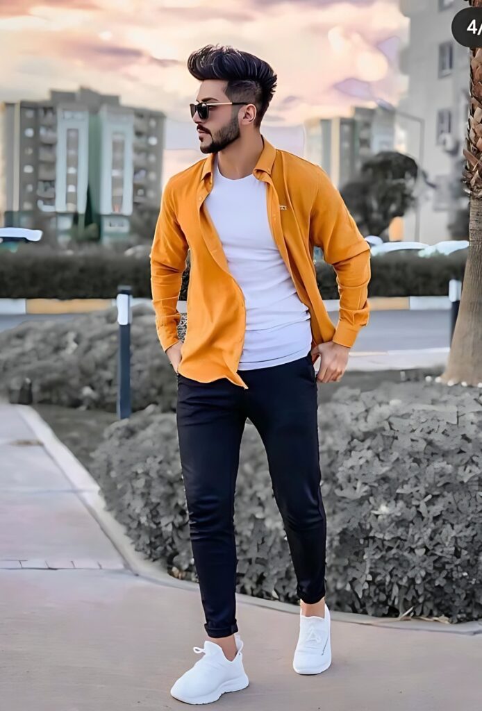 Single stylish boy wearing orange shirt over white t-shirt, black pants and white sneakers, posing confidently on street with modern hairstyle