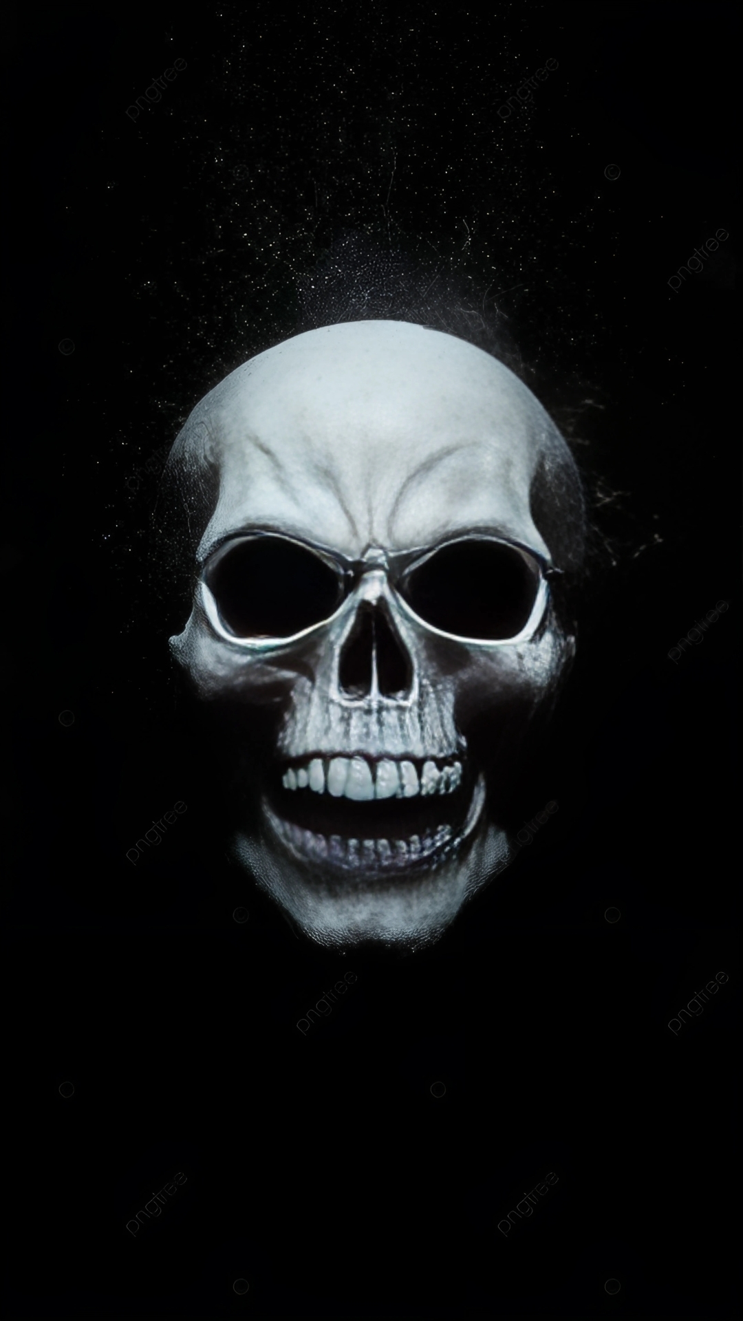 Realistic human skull glowing in the dark with dramatic shadows on a black background