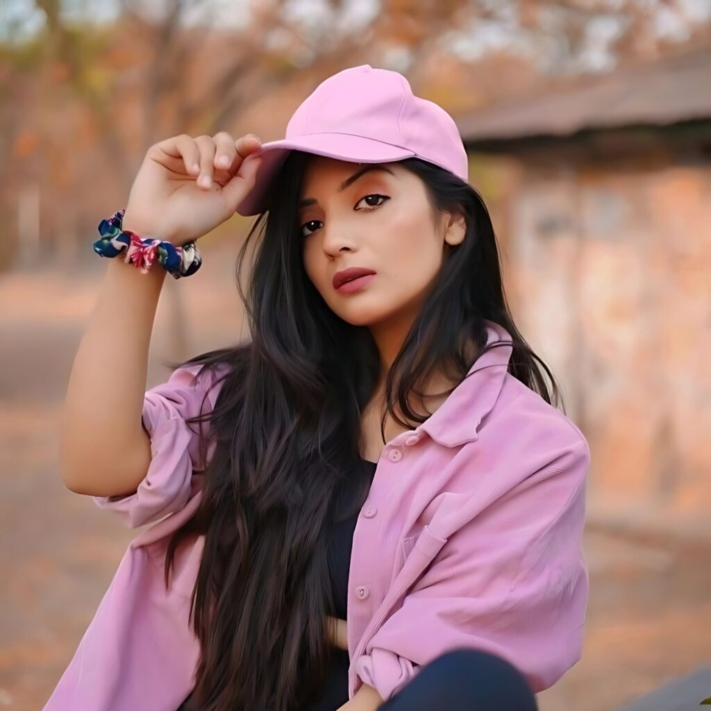 Confident girl wearing a pink cap and shirt, striking an attitude pose outdoors – ideal attitude girl DP for WhatsApp.