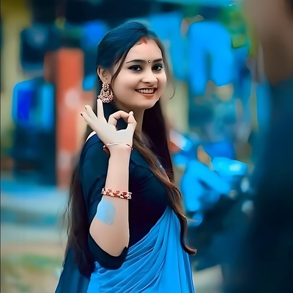 Smiling Indian girl in blue saree giving OK hand sign – stylish and cool WhatsApp DP photo for girls.