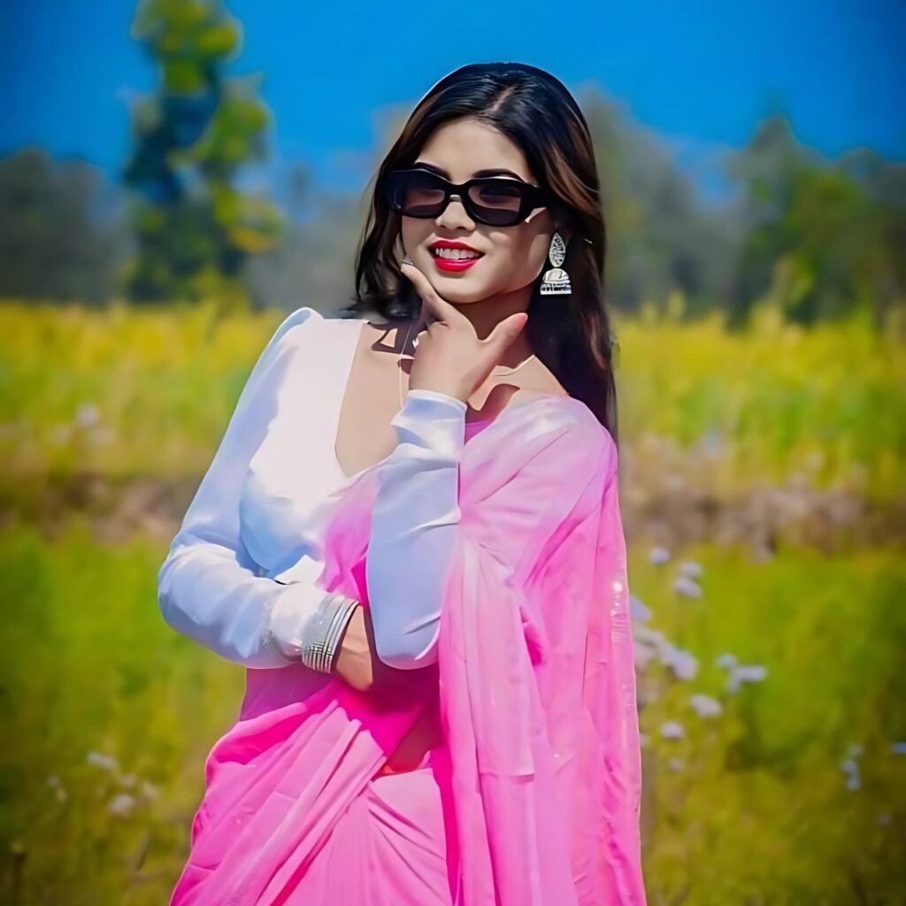 Beautiful Indian girl in pink saree and sunglasses smiling confidently in a scenic field – perfect cute WhatsApp DP.