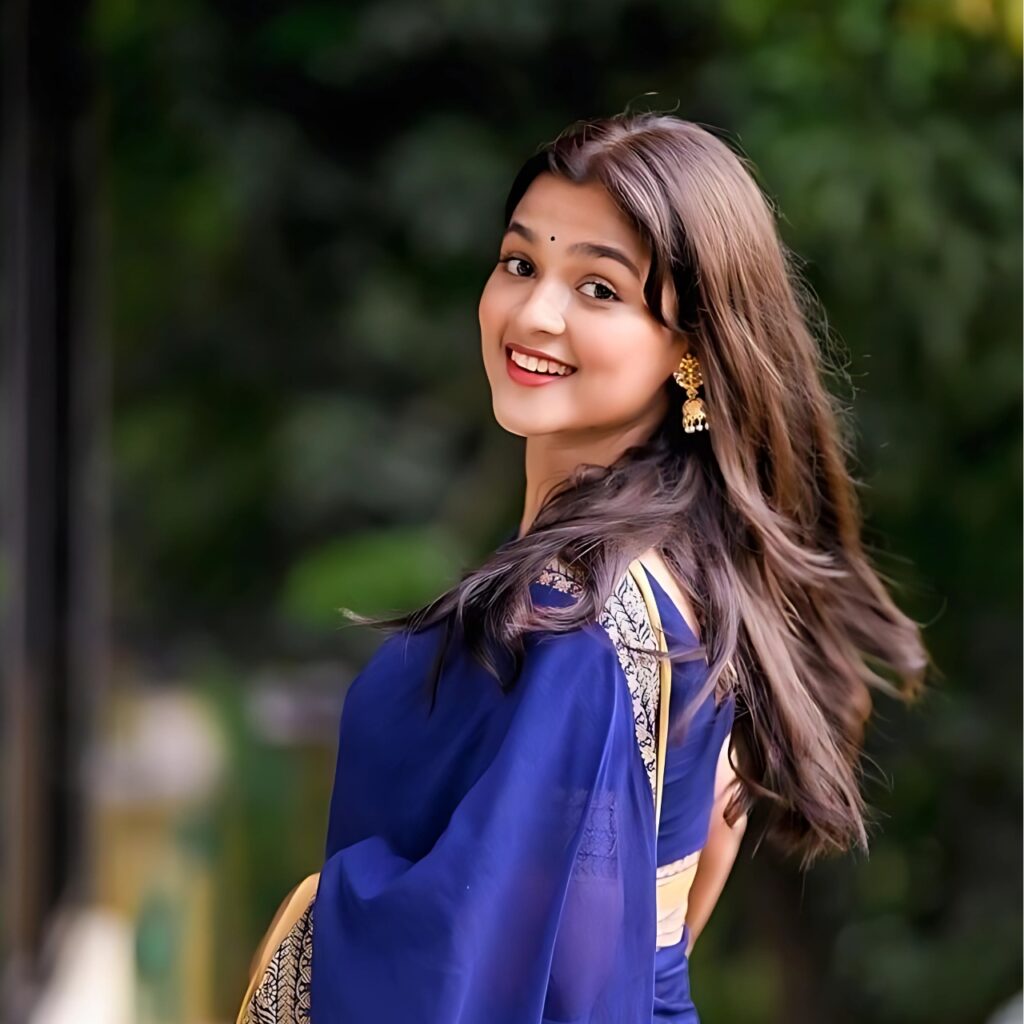 Beautiful Indian girl in traditional blue saree smiling – perfect WhatsApp DP for girls.