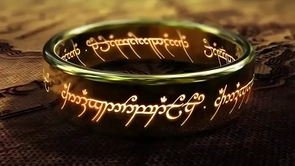 Lord of the Rings desktop wallpaper featuring the glowing fiery One Ring resting on a map of Middle-earth with Elvish inscription illuminated.