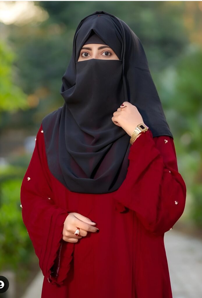 Hijab girl standing in a garden wearing a red dress and black niqab – beautiful Muslim girl profile picture HD.