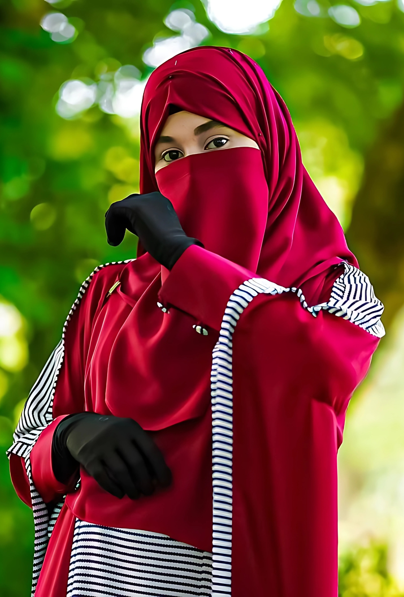 Stunning hijab girl in a red abaya and black gloves, posing modestly in nature – perfect 4K HD wallpaper for Islamic and hijab-themed profiles.