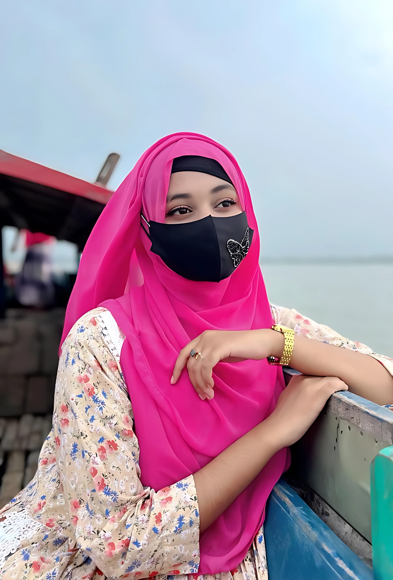 Islamic girl wearing a pink hijab and black face mask standing on a boat – HD profile photo