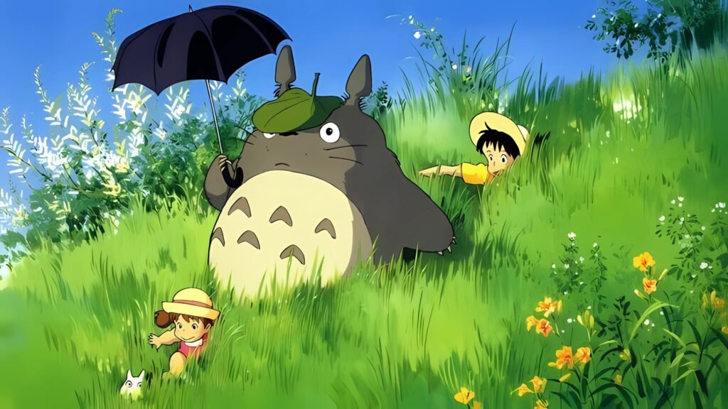 Desktop wallpaper from My Neighbor Totoro featuring Totoro holding an umbrella, relaxing in a green meadow with Mei and Satsuki