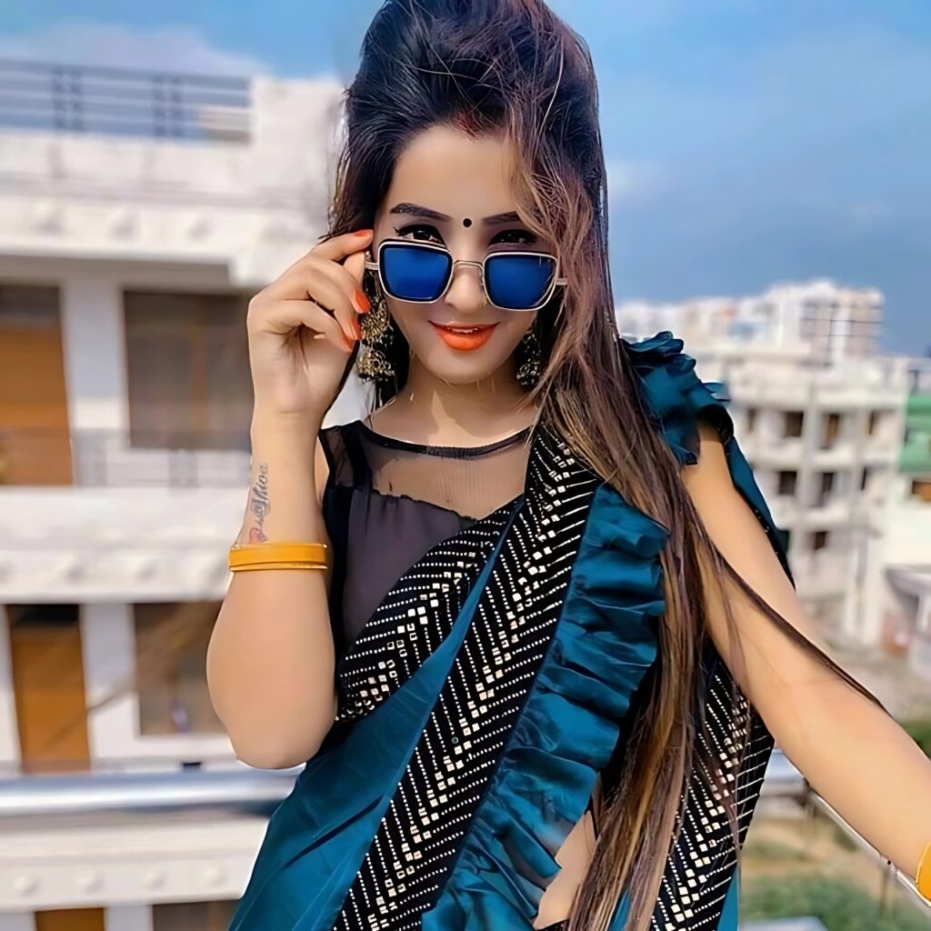 Confident Indian girl in blue saree wearing sunglasses – bold attitude pose for WhatsApp DP