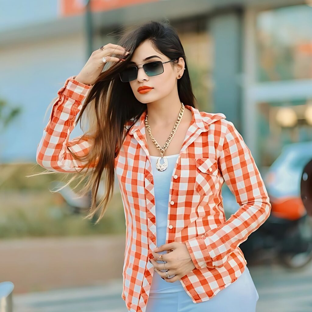 Stylish girl in red checkered shirt and sunglasses posing confidently outdoors – perfect WhatsApp DP for girls.
