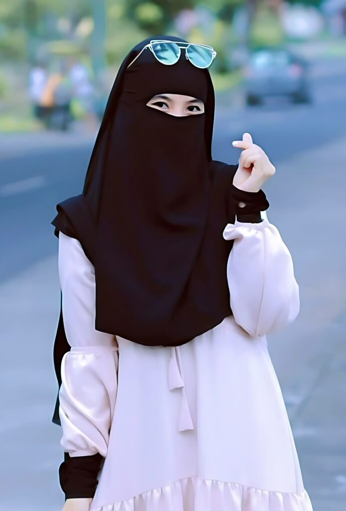 Hijab girl in black niqab and soft pink dress with sunglasses – modern and modest WhatsApp DP.